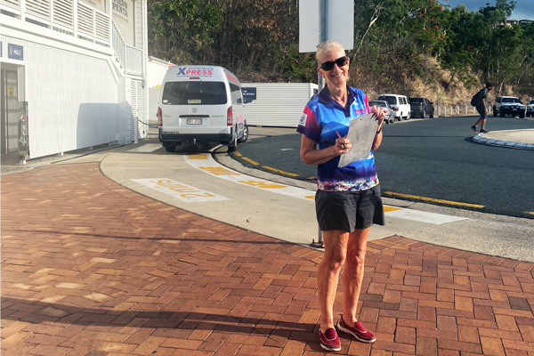 woman standing holding a clipboard